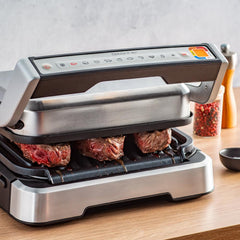 Meat being cooked in the OptiGrill on countrtop