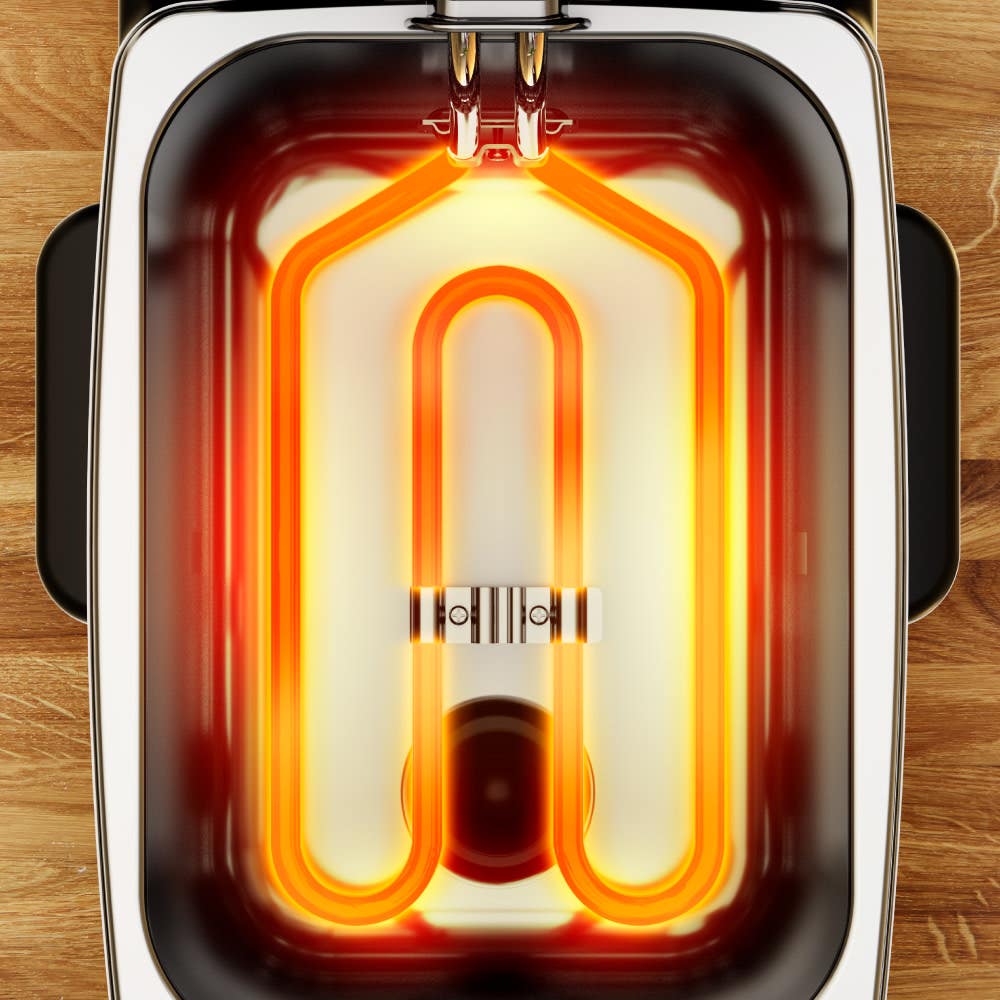 Golden heating element inside a deep fryer with a rectangular shape on a wooden surface, evenly glowing to indicate it is in operation, providing efficient heat for frying.