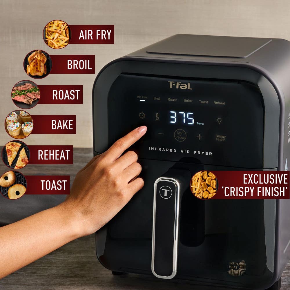 Hand selecting settings on the T-fal Air Fryer's digital touch screen, showcasing versatility with options to air fry, broil, roast, bake, reheat, and toast with exclusive crispy finish