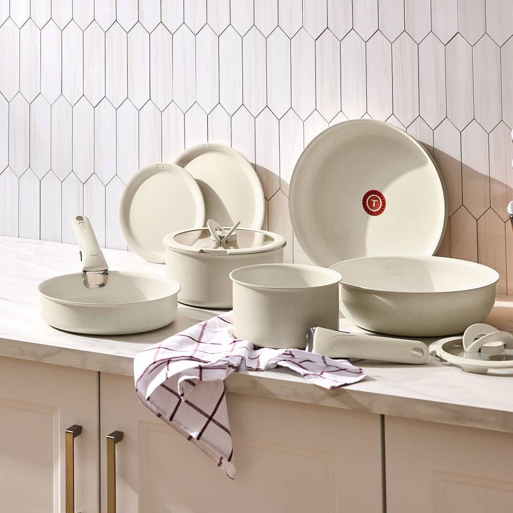 Beige cookware set with detachable handle, featuring nonstick surfaces and pans with meals