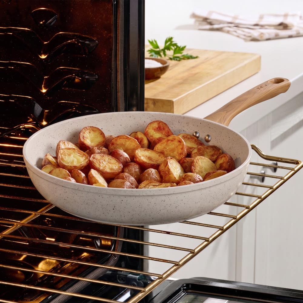 T-fal ceramic beige frypan roasting golden potatoes on an oven rack
