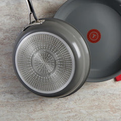 Two skillets, one showing the interior and the other the induction compatible textured bottom.