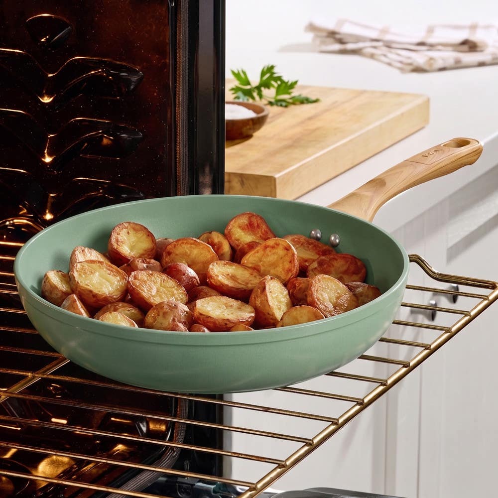 T-fal green ceramic frypan roasting golden potatoes on an oven rack