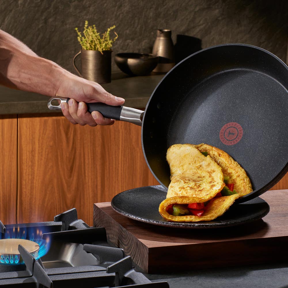 Serving an omelet from a Stone Force Frying Pan to a plate.