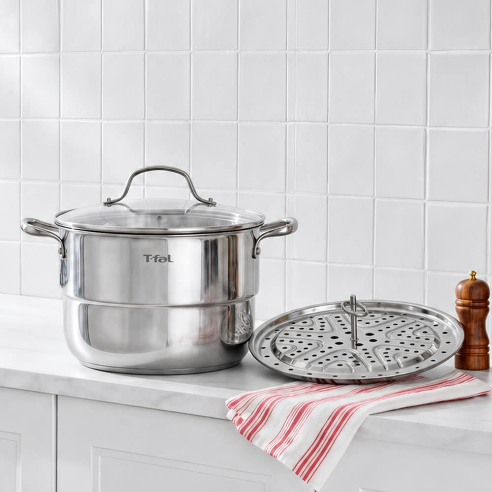 T-fal stainless steel steamer pot with glass lid and perforated insert on kitchen counter