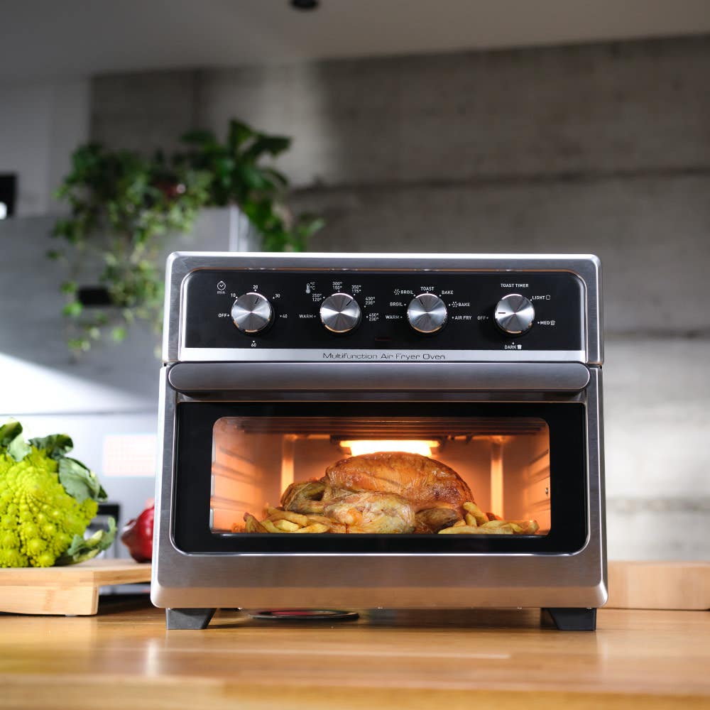 The easy fry oven cooking chicken and fries in kitchen countrtop