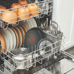 Dishwasher loaded with plates, cups,and stainless steel cookware with non-stick interior