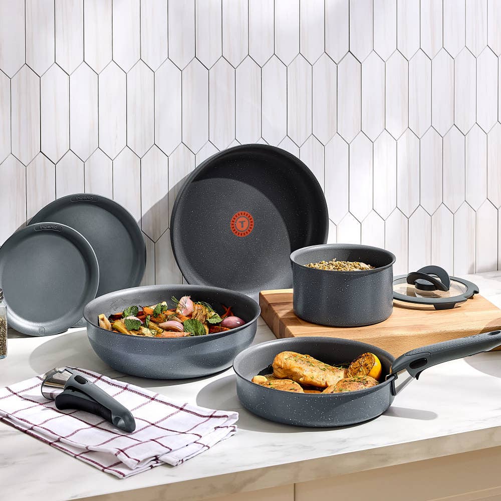Gray cookware set with detachable handle, featuring non-stick surfaces and pans with meals
