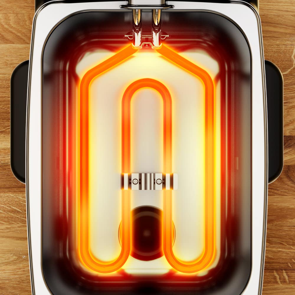 Golden heating element inside a deep fryer with a rectangular shape on a wooden surface, evenly glowing to indicate it is in operation, providing efficient heat for frying.
