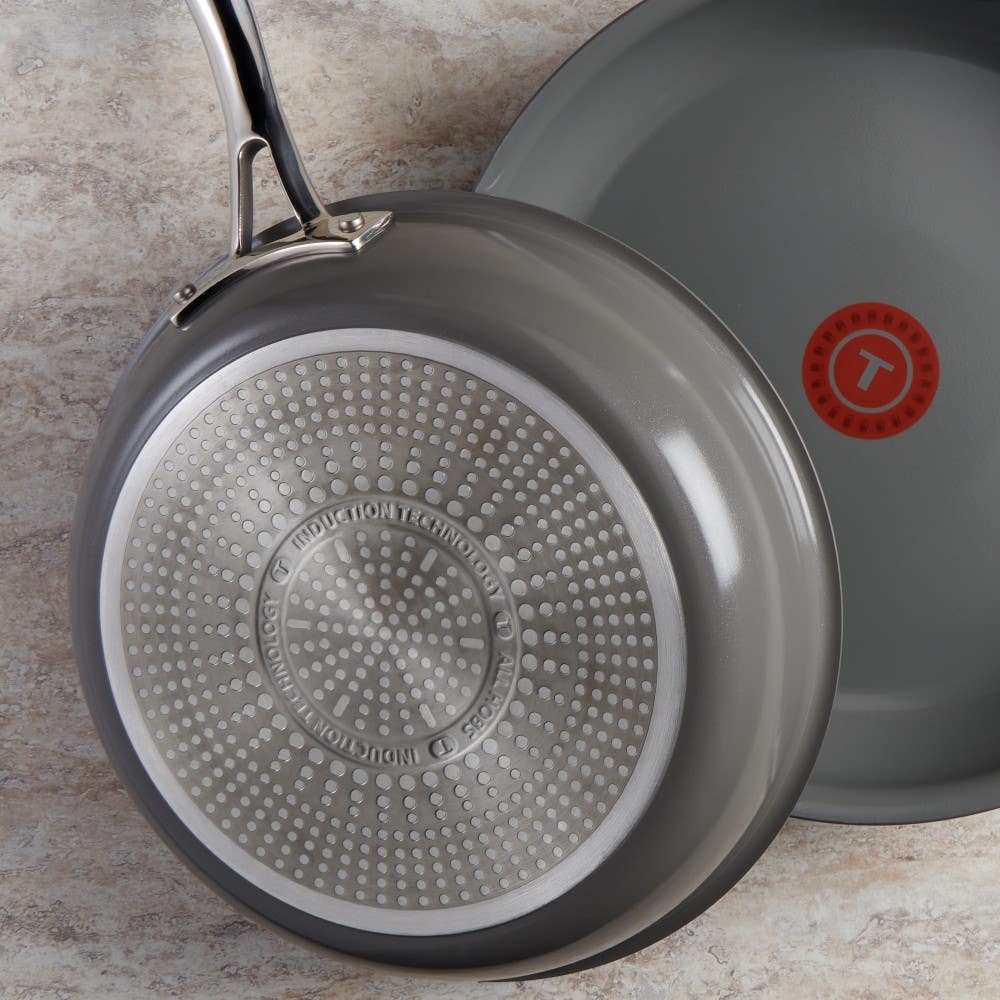 Two skillets, one showing the interior and the other the induction compatible textured bottom.