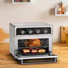 A chicken and seasoned tomatoes inside the easy fry oven after beeing cooked
