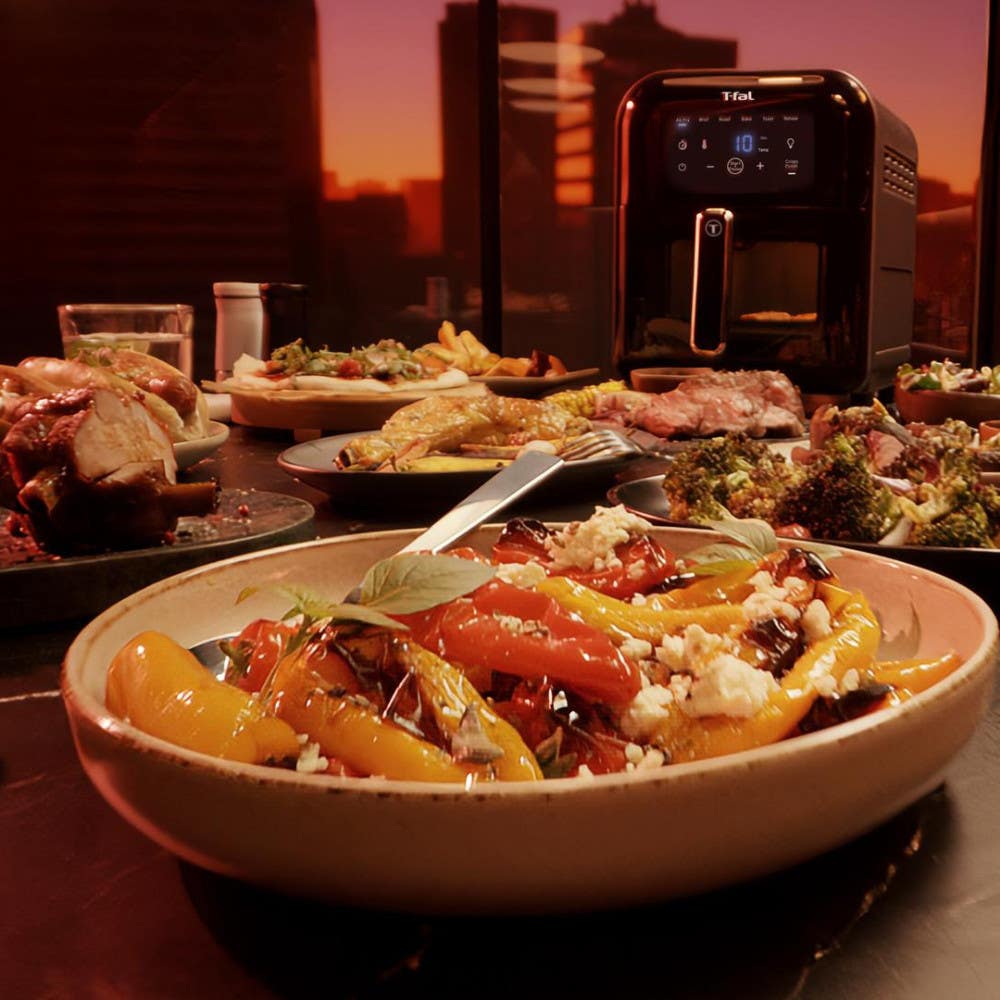 A set dining table with various dishes, featuring the T-fal Infrared Air Fryer in the backgroundset dining table with various dishes, featuring the T-fal Infrared Air Fryer in the background