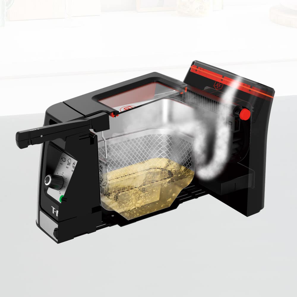 Transparent view of deep fryer with steam and fries inside the basket.