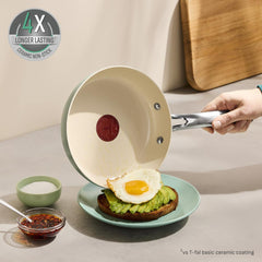 Ceramic pan slides egg onto toast, 4X longer-lasting badge vs T-fal basic coat.