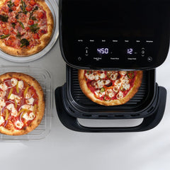 Infrared Surface XXL Air Fryer by T-fal with digital display, cooking a pizza inside, surrounded by two prepared pizzas on a clean surface