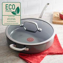 A closed pan with an "Eco Pack" label on a red cloth; a bowl of cheese in the background.